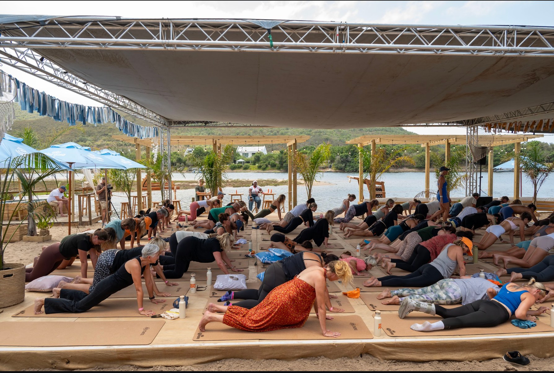 Sunshine People guests taking part in a group movement session beside the river